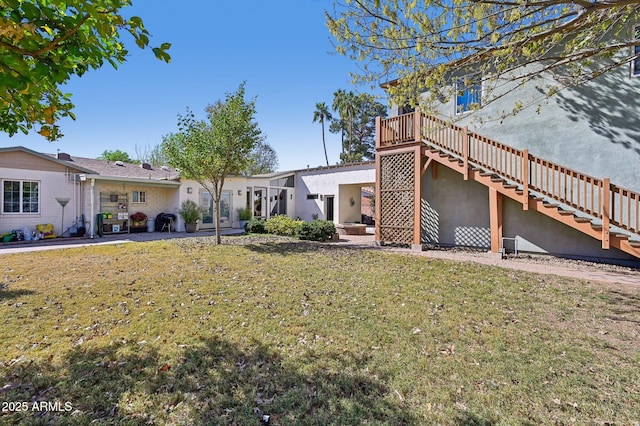 view of yard featuring a patio and stairway