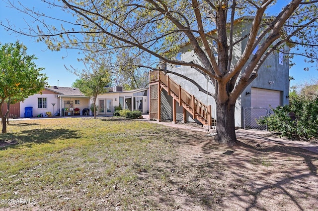 single story home featuring french doors, stairway, and a front lawn