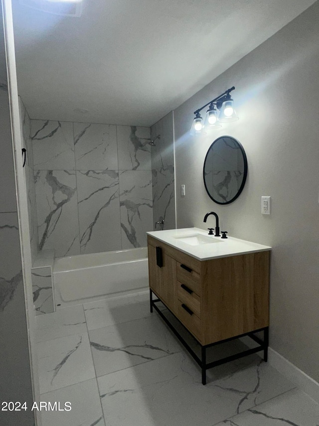 bathroom with tiled shower / bath combo and vanity