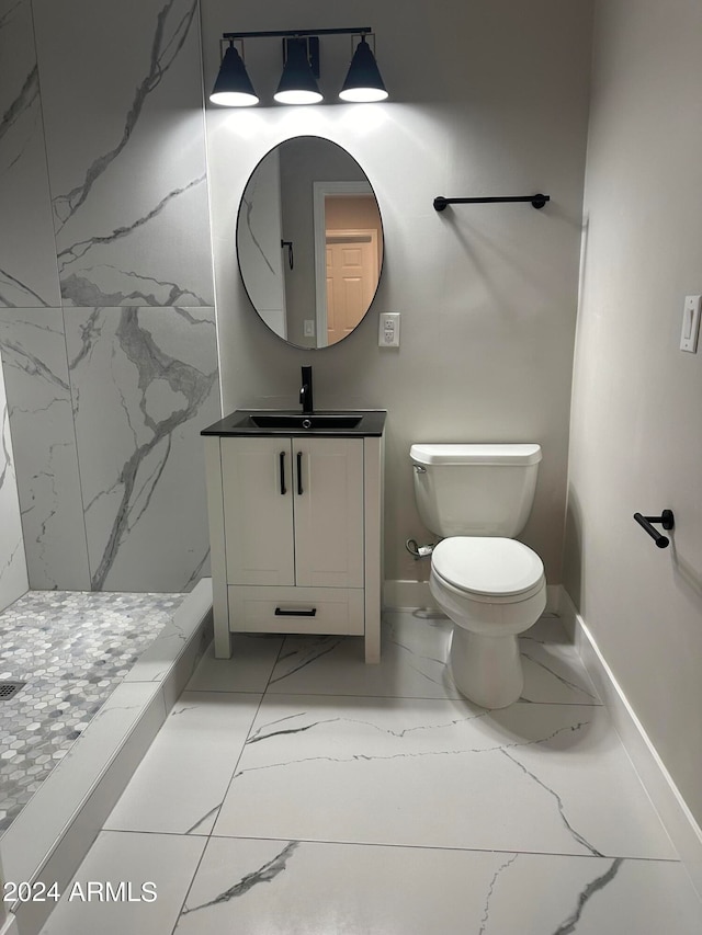 bathroom with vanity, a shower, and toilet