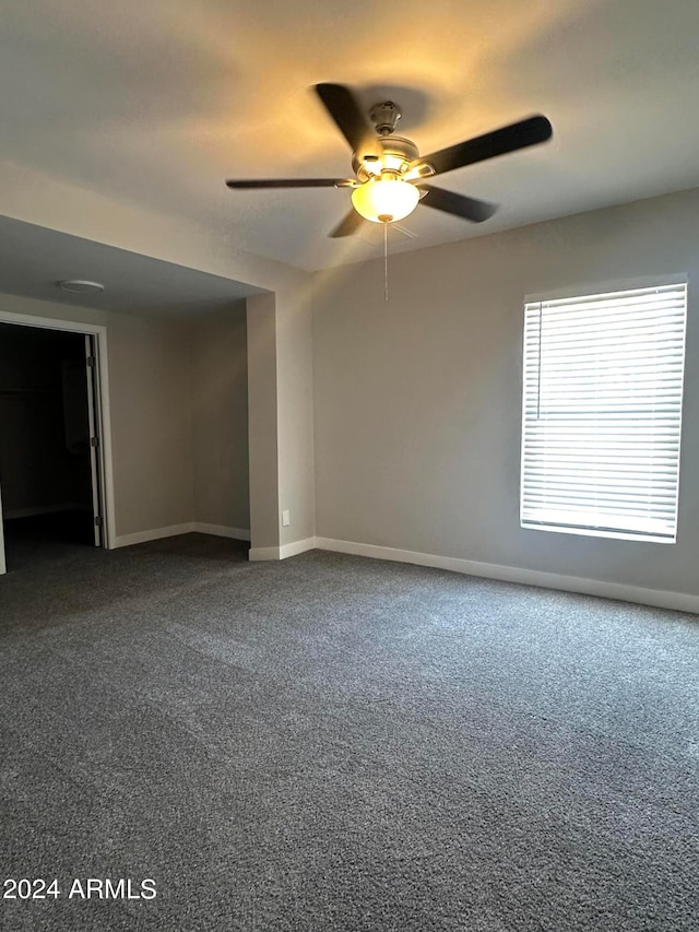 spare room with carpet floors and ceiling fan