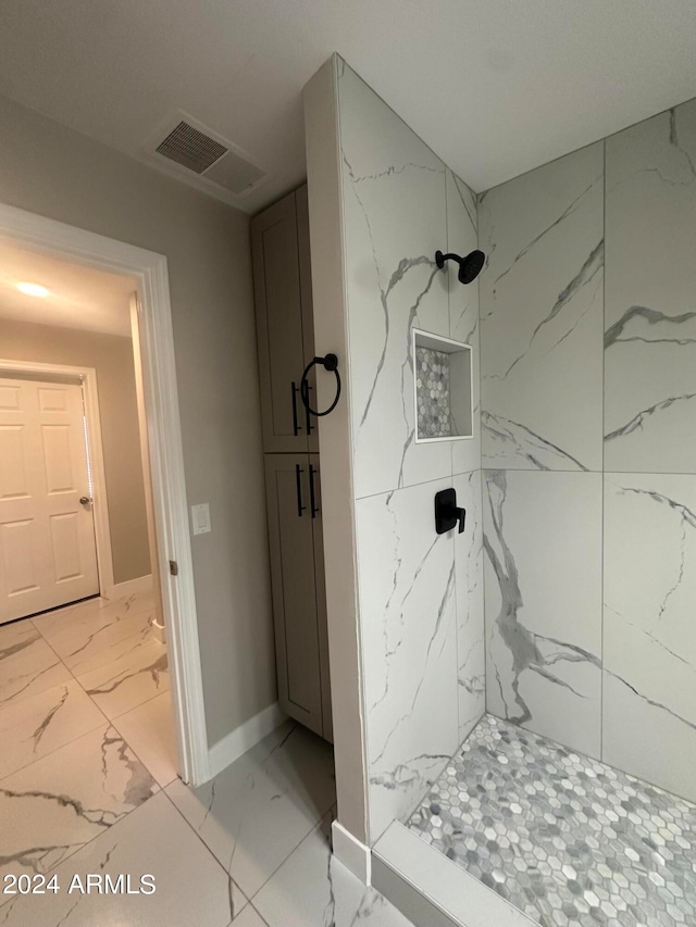 bathroom with a tile shower