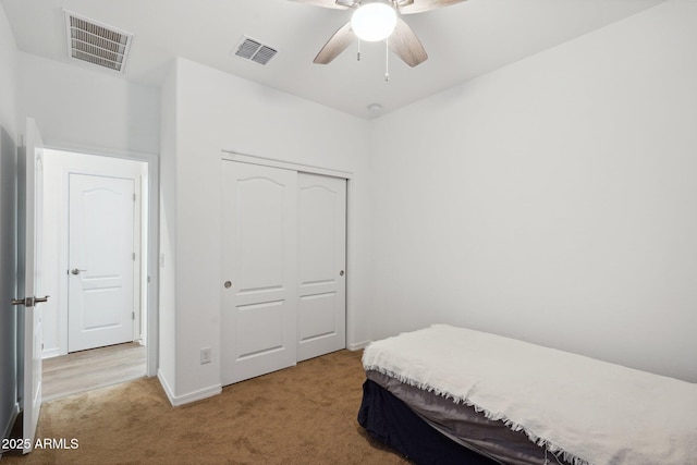 bedroom with carpet floors, a closet, visible vents, and baseboards