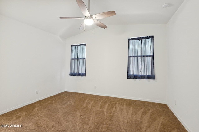 unfurnished room featuring carpet, baseboards, and vaulted ceiling