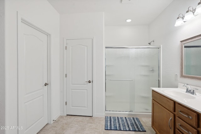 full bathroom with a shower stall and vanity