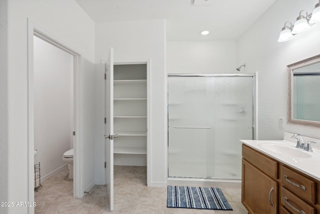 full bathroom featuring toilet, tile patterned flooring, a shower stall, and vanity