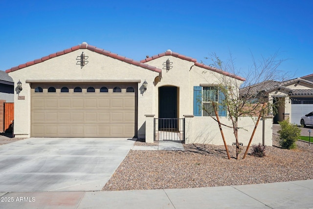 mediterranean / spanish home featuring a garage, driveway, a tiled roof, and stucco siding