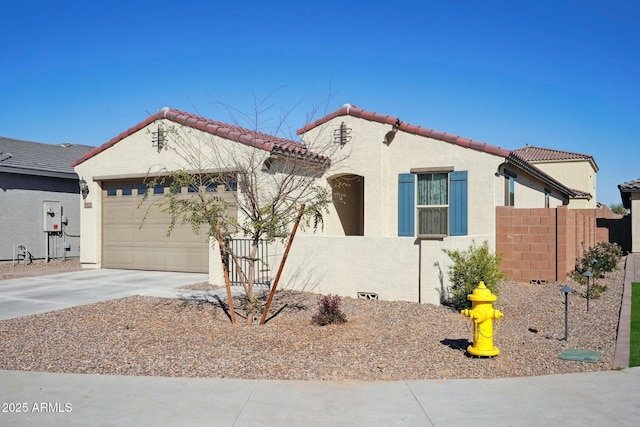 view of front facade featuring a tile roof, stucco siding, concrete driveway, an attached garage, and fence