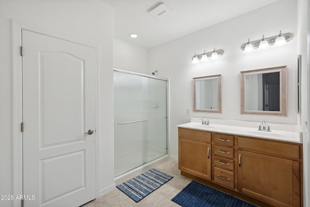 bathroom with double vanity, a sink, and a shower stall