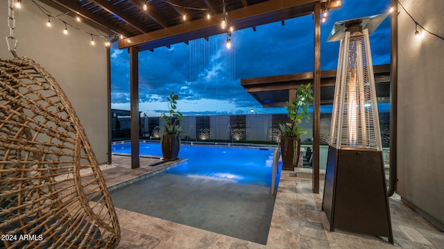 pool at dusk featuring a patio