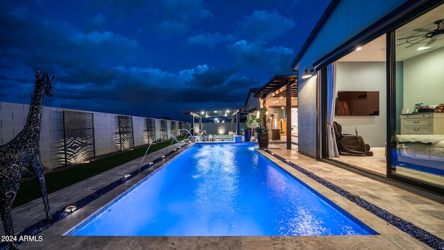 pool at night with a pergola and pool water feature