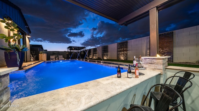 pool at dusk with pool water feature