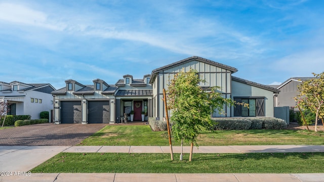 view of front of house featuring a garage and a front lawn