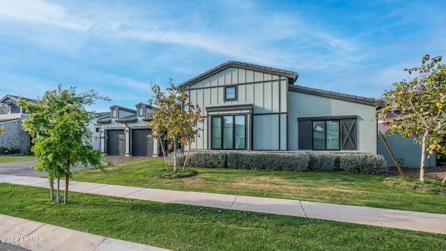 view of front of home featuring a garage and a front yard