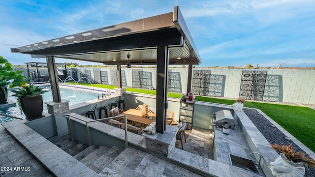 view of patio featuring pool water feature and a fenced in pool