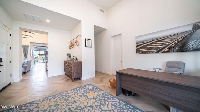 home office with a notable chandelier and parquet floors