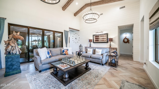 living room featuring high vaulted ceiling, beamed ceiling, parquet floors, and a chandelier