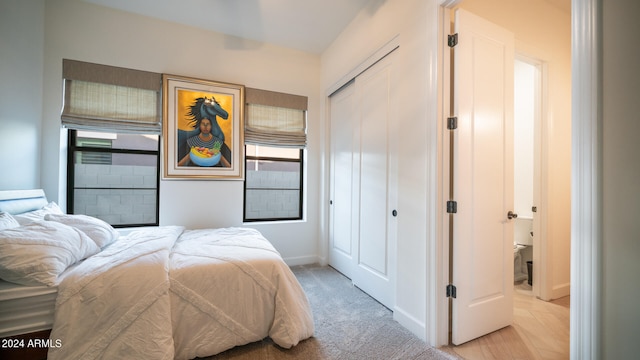 bedroom featuring a closet and light carpet