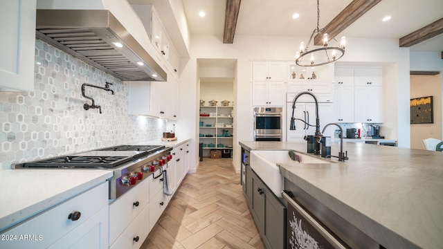 kitchen with tasteful backsplash, white cabinets, and light parquet flooring