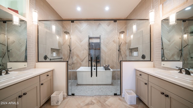 bathroom with dual bowl vanity, tile floors, and tile walls