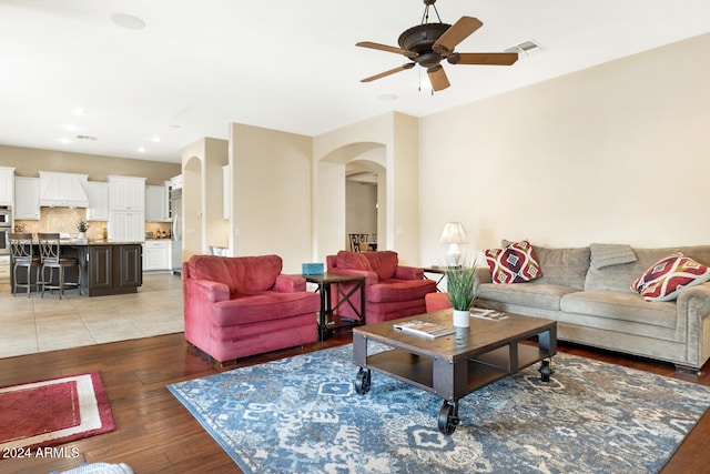 living room with ceiling fan and wood-type flooring