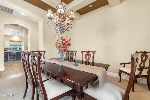 dining room featuring light tile patterned floors, beverage cooler, and an inviting chandelier