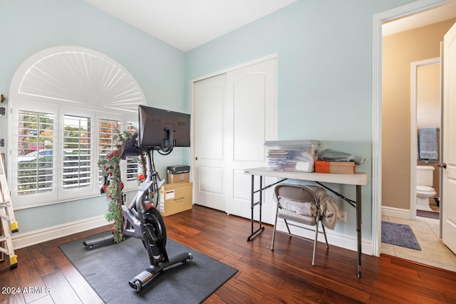 exercise area with dark hardwood / wood-style flooring