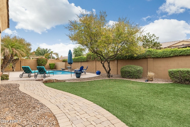 view of yard featuring a patio area and a fenced in pool