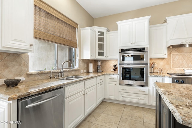 kitchen with white cabinets, stainless steel appliances, tasteful backsplash, and sink