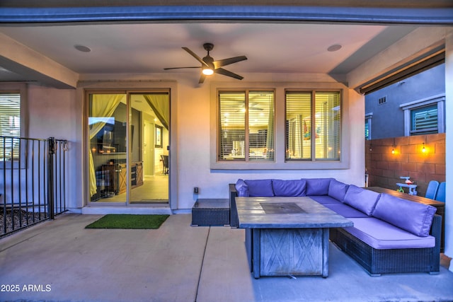 view of patio with a ceiling fan, an outdoor living space with a fire pit, and fence
