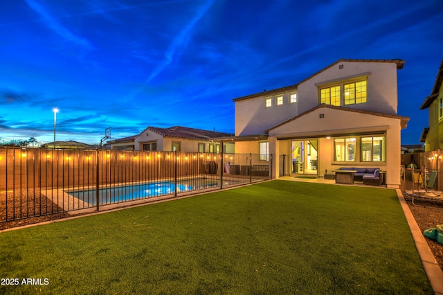 back of house with a fenced in pool, a fenced backyard, stucco siding, a patio, and an outdoor living space