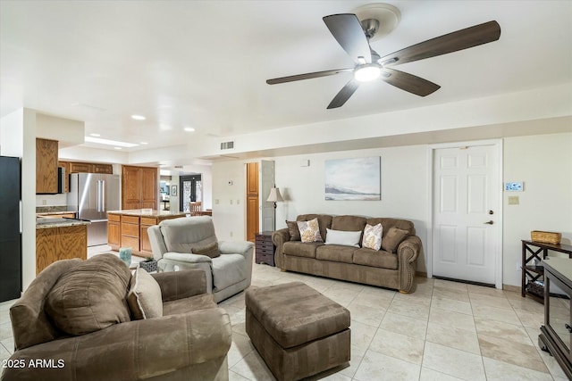 living area with light tile patterned floors, a ceiling fan, visible vents, and recessed lighting