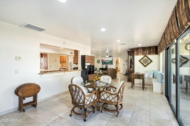 dining room featuring visible vents, arched walkways, baseboards, ceiling fan, and recessed lighting