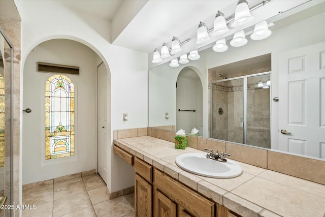 bathroom with a shower stall, vanity, and tile patterned floors