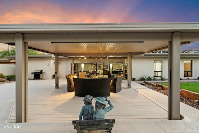 view of patio with outdoor dining area, area for grilling, a wooden deck, and an outdoor living space