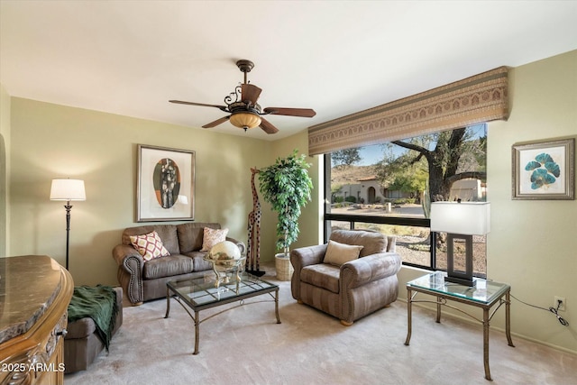 carpeted living room with a ceiling fan