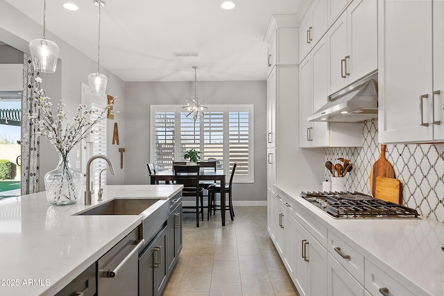 kitchen featuring sink, white cabinetry, pendant lighting, and appliances with stainless steel finishes