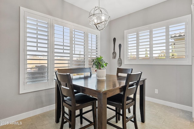 tiled dining area featuring a chandelier and a wealth of natural light