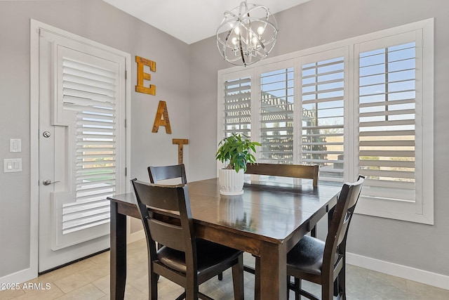 dining area with a healthy amount of sunlight, light tile patterned floors, and an inviting chandelier