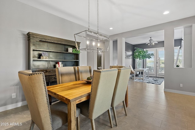 dining area with ceiling fan with notable chandelier