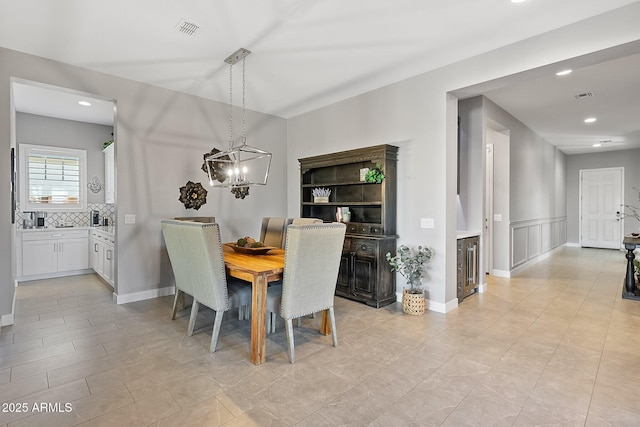 dining space with an inviting chandelier