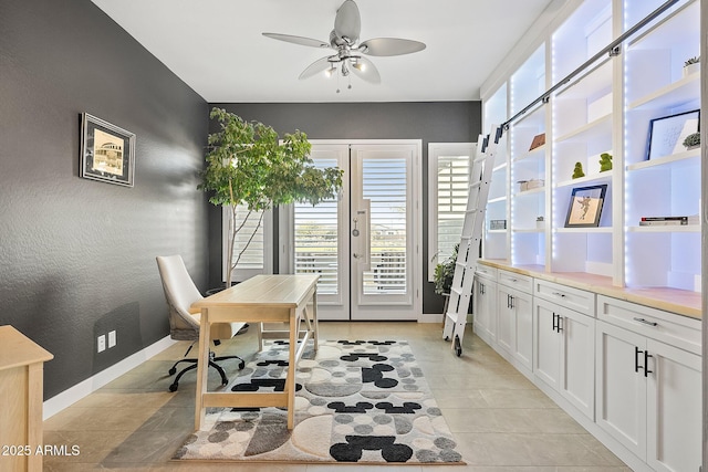 office with ceiling fan and french doors