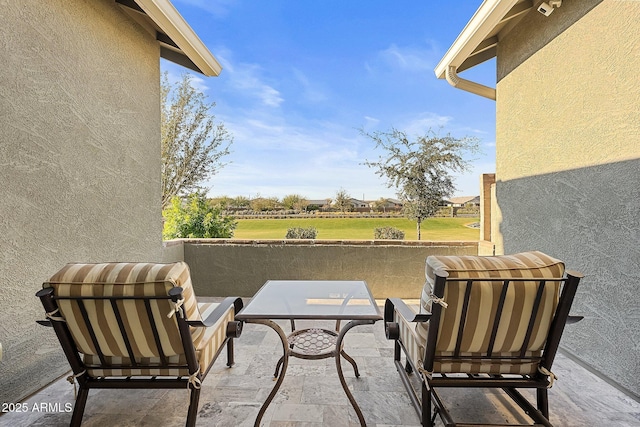 view of patio featuring a balcony