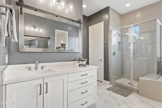 bathroom with an enclosed shower and vanity