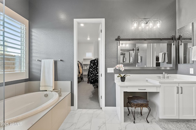 bathroom with tiled bath and vanity