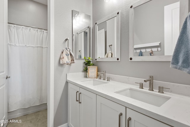 bathroom featuring tile patterned flooring and vanity