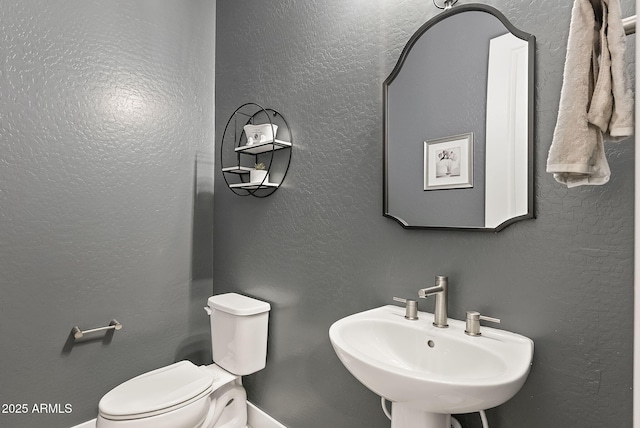 bathroom featuring sink and toilet