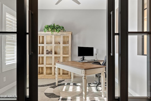 office with ceiling fan and plenty of natural light