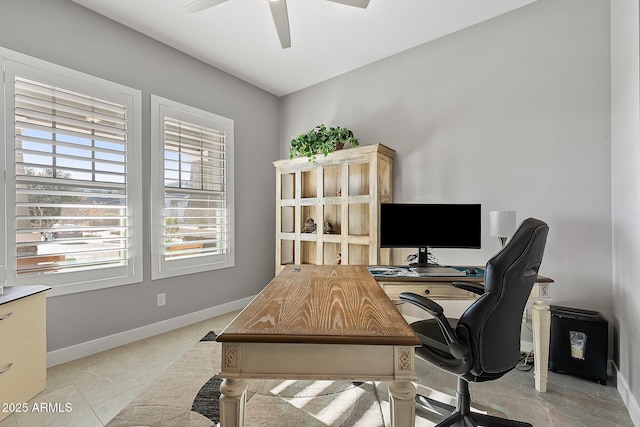 office space with light tile patterned floors and ceiling fan