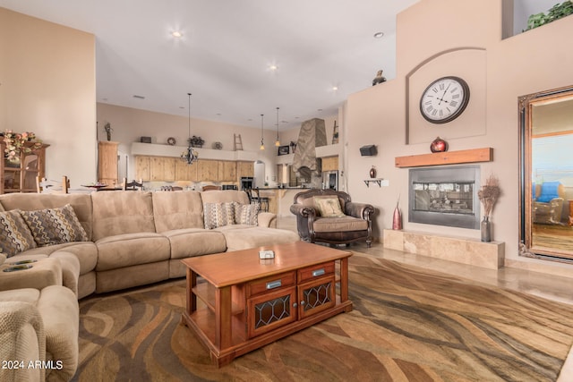 living room with a towering ceiling and a fireplace